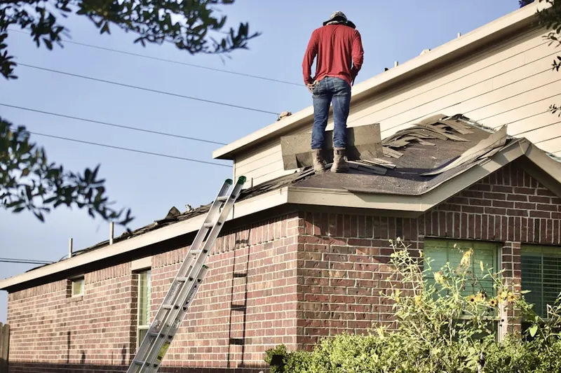 Professional roofer working on a residential roof in Oak Harbor